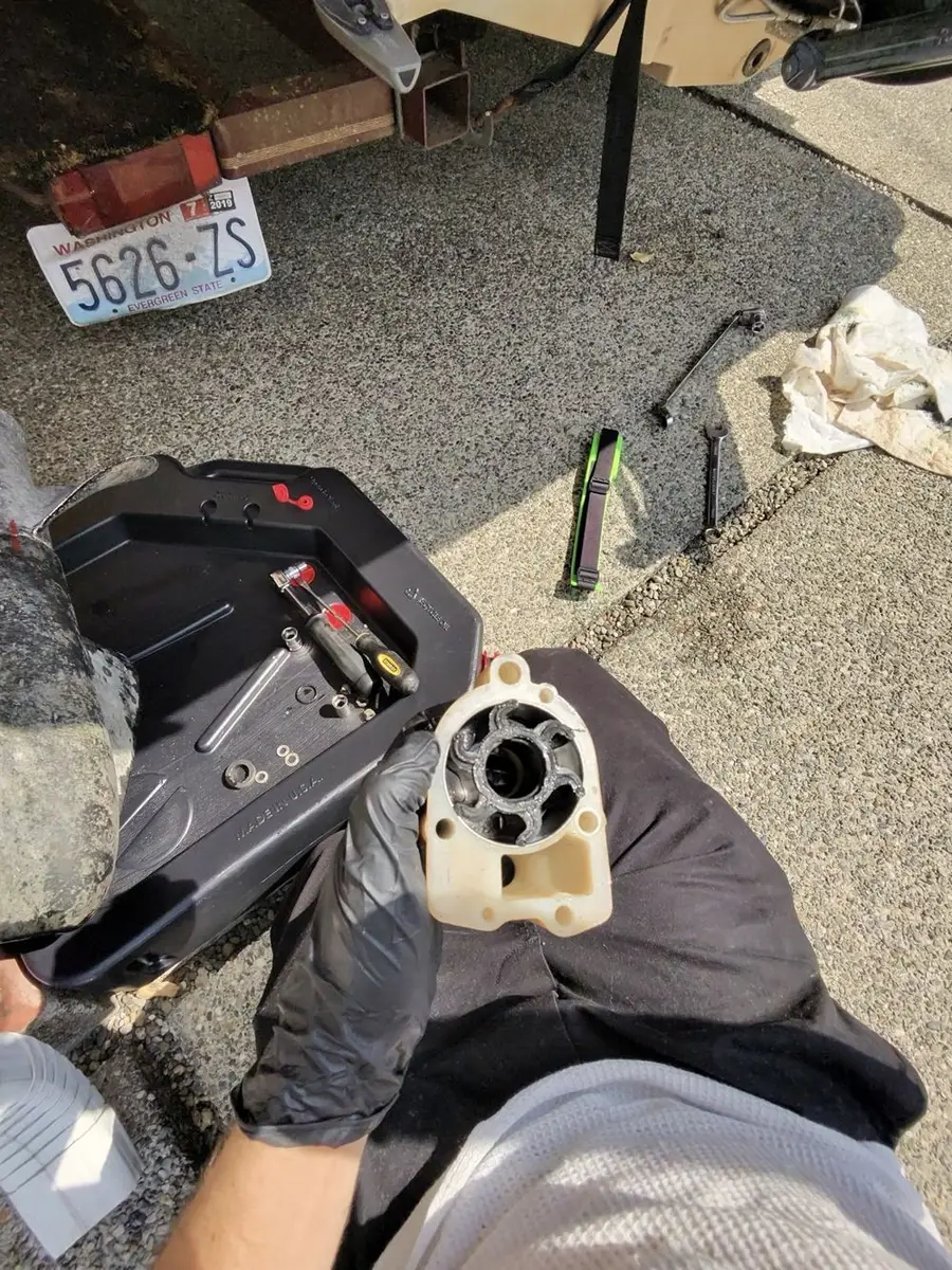 Damaged marine raw-water pump inspected during a dockside boat repair in Seattle